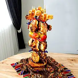 Breads and candies strung on vertical sticks