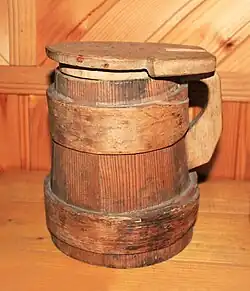 A wooden bucket with a lid