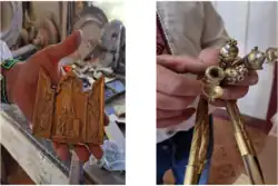 A man holding various decorated objects made of a yellow metal