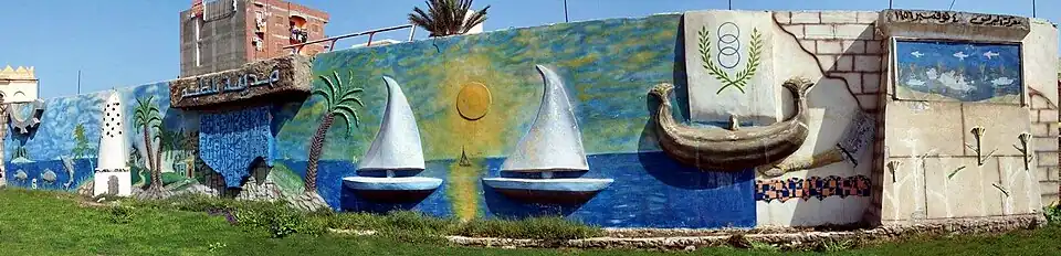 The governorate's emblem on a mural in the city of Baltim.