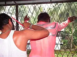 Artist painting tiger stripes on the back