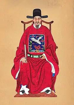 Vietnam's Trần Danh Án wearing an ô sa mạo hat (mũ cánh chuồn) influenced by wushamao