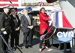 Susan Ford Bales, daughter of President Gerald R. Ford, christening the aircraft carrier