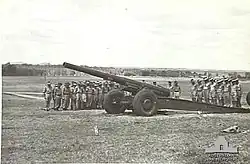 'T' Australian Heavy Battery at Fort Lytton with M1917/1918 155-millimetre (6.1 in) heavy gun. Heads are bowed during a ceremony on Armistice Day 1943[gallery 19]
