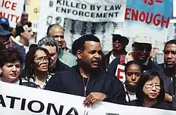 Joe Madison leads a group of protesters