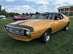 Shows a 1971 AMC Javelin AMX 401 in Mustard Yellow at 2015 AMO show