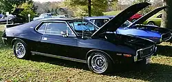 shows a factory original 1973 Javelin AMX finished in black with a 401 "Go Pac"