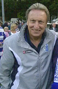 A man wearing a grey rain jacket.
