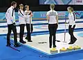 Team Norway discusses the last stone in the last end