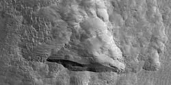 Close view of depression, as seen by HiRISE under HiWish program Straight, steep wall near the bottom faces the north pole.