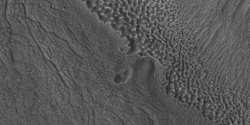 Close view of contact, as seen by HiRISE under HiWish program Picture shows details of how upper plains material is breaking. The formation of many fractures seems to proceed the break up.