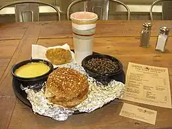 The pulled pork sandwich with cheese grits and wild rice, purchased on opening day