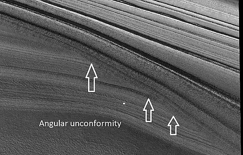 Close view of layers in northern ice cap, as seen by HiRISE under HiWish program. Arrows point to an angular unconformity.