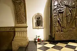View of Norwid's epitaph plaque and urn with soil from his grave