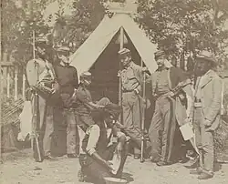 Soldiers standing in front of a tent