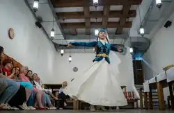 Crimean Tatar woman in traditional clothing dancing
