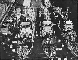 ABSD-3 repairing small ships (likely Admirable-class minesweepers or PCE-842-class patrol craft) at the same time at Guam in 1945