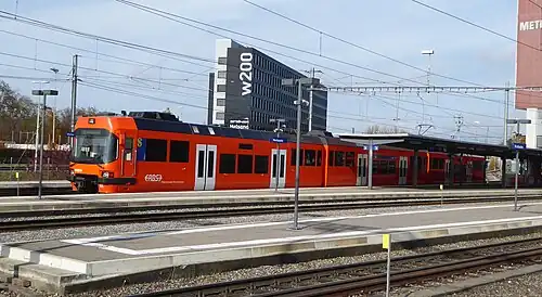 Orange train at island platform