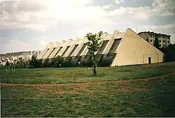 The sports center features brutalist architecture, in line with the overall campus design.
