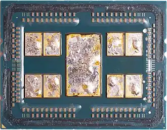 A delidded AMD 7702 featuring 8 CCDs and 1 I/O die, with remains of the solder thermal interface material (TIM) on the chiplets