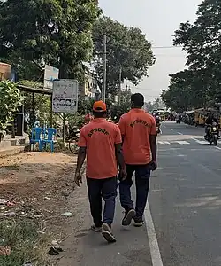 Two APSDRF Personnel walking at 2023 Andhra Pradesh train collision site.