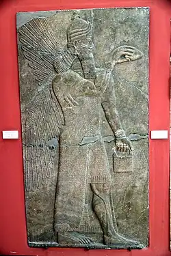 A human-headed and winged apkallu holding a pine cone and bucket for religious rituals (Museum of the Ancient Orient)