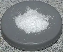 Some white powder on a round gray platform.