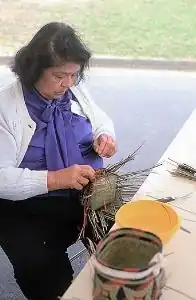 Ada Thomas, a Chitimache artist from Louisiana, weaves double-woven baskets