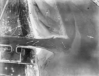 Aerial photograph showing the blockships sunk after the Zeebrugge Raid. HMS Iphigenia is second from left
