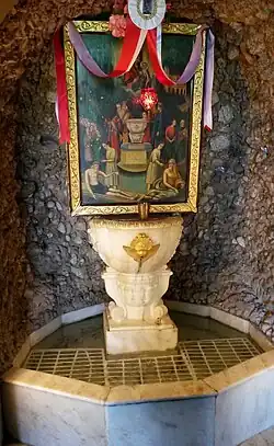 The sacred spring at the entrance of the church of Panagia Trypiti. On the marble fountain it is written the palindrome, "Wash [the] sins, not only [the] face" ΝΙΨΟΝ ΑΝΟΜΗΜΑΤΑ ΜΗ ΜΟΝΑΝ ΟΨΙΝ ("Nipson anomēmata mē monan opsin"