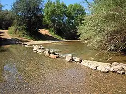 Stepping stone crossing next to a fording point on the river
