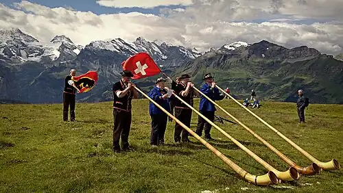 Image 4Some of the traditional symbols of Switzerland: the Swiss flag, the alphorn and the snow-capped Alps (from Culture of Switzerland)