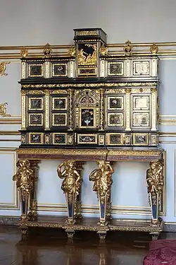 Cabinet with caryatids; c.1675; ebony, kingwood, marquetry of hard stones, gilt bronze, pewter, glass, tinted mirror and horn; unknown dimensions; Musée des Arts décoratifs, Strasbourg, France[124]
