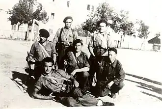Photograph of Téllez, lying on the ground, with his guerrilla unit