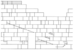 Architectural black on white sketch of a wall missing some stones, with a door at the center and carving marks on the wall surface.