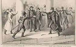 Several people in a crowd, man aims a gun at Jackson