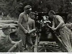 Gunners load and fire an artillery piece