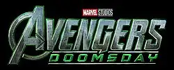 The logo of Avengers: Doomsday, depicting the standard Avengers logo with the green and grey colors and a metallic design similar to Doctor Doom's armor, and the word "Doomsday" in smaller text underneath.