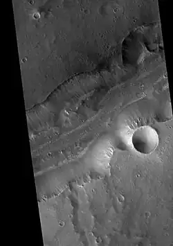 Bahram Vallis in the Lunae Palus quadrangle of Mars, as seen by HiRISE. Rotational landslides (slumps) are visible at the base of north wall.