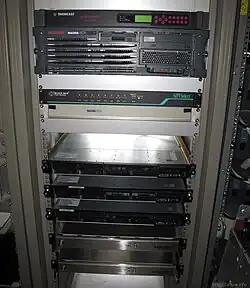 In the bottom half of the image: Viaccess encryption and conditional access system with 3 black rackmount servers and 2 silver devices which are card readers