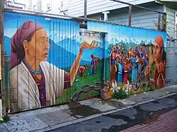 A Precita Eyes' mural on a garage door and fence in Balmy Alley