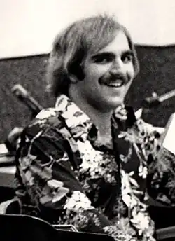 Banana Joe smiling next to microphones