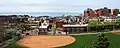 Baseball field in the foreground, with residential dwellings in the center of the image, and the Children's Hospital of Pittsburgh in the background