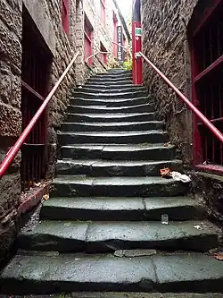 A view on stairs, where the central part deteriorated from people using mostly the middle section of each step.