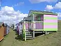 Colourful rows of wooden huts on the grassy slopes of "Tankerton slopes" below Marine Parade