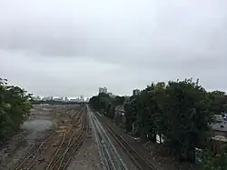 Beacon Park Yard in 2016, with all but seven yard tracks removed. The second track from the right was converted from a yard track to a mainline track to improve commuter rail capacity and reliability.