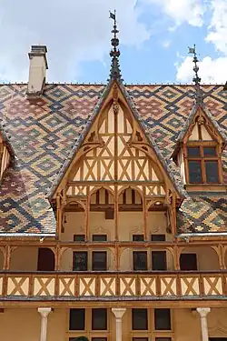 Gothic – Hôtel-Dieu de Beaune, Beaune, France, by Jacques Wiscrère, 1451[28]