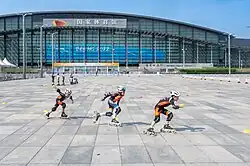 Child roller skaters in front of National Indoor Stadium in Beijing, China, 2024
