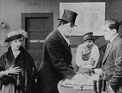 Black and white film still showing a girl and man