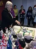 Betty Kitchener cutting cake at celebration of one million first aiders trained worldwide, Melbourne, June 2015